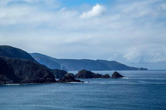 Calm ocean and distant rugged coastal headlands.