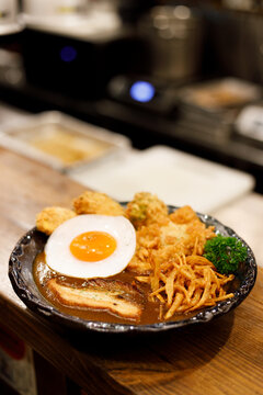 Japanese curry rice dish with thick and spiced sauce pairing with variety of meat.