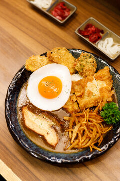Japanese curry rice dish with thick and spiced sauce pairing with variety of meat.