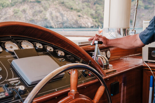 Captain's Hand on Traditional Wooden Gulet Steering Wheel