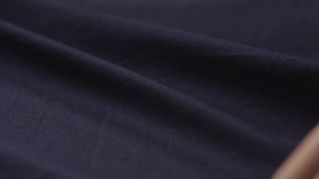Slow motion man hand checking blue cotton shirt cloth