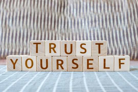 motivational phrase Trust Yourself made of letters on wooden cubes