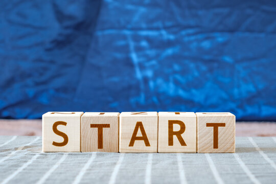 motivational word Start made of letters on wooden cubes