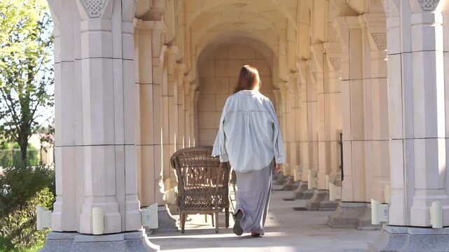 Woman Walking Arched Corridor Stone Building Outdoor