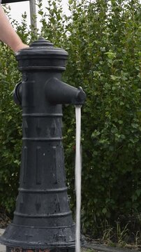 Turning on vintage public water pump vertical video