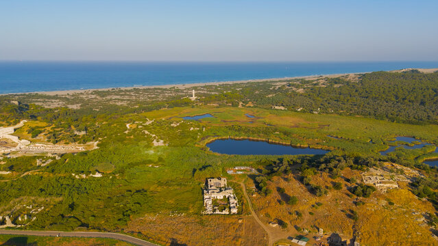 Gelemis, Turkey. Panoramic view of Patara ancient city with gate, road, Hurmalik Hamami at Tepecik, beach and mediterranean sea. Aerial View