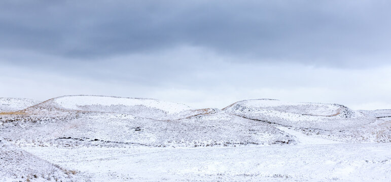 Panoramic view of Snow covered calderas in the volcanic landscape of Lake Myvayn, Iceland. These geological craters are formed when a major eruption causes the volcano to collapse on itself.