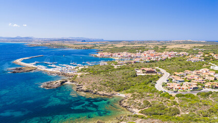 Fototapeta premium Aerial view of Stintino harbor and coastline on the northwestern coast of Sardinia, Italy, overlooking the crystal-clear waters of the Gulf of Asinara
