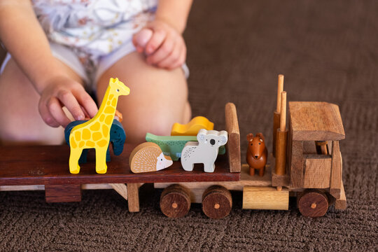 Child playing with animals on flatbed truck for imaginative play