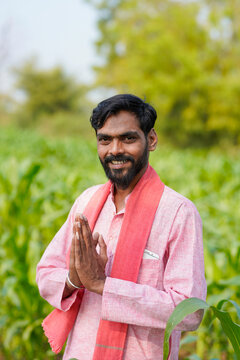Indian farmer doing namaste or welcome gesture at agriculture field