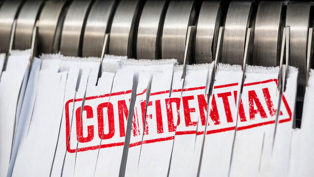 A close-up view of confidential documents in a metal file organizer