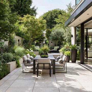 Contemporary patio garden with large stone tiles, outdoor dining set, surrounding greenery, seamless indoor-outdoor living concept