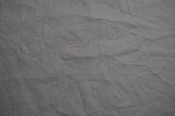 Fototapeta premium Close-up of textured gray fabric with woven pattern. Industrial material background for design and fashion projects.