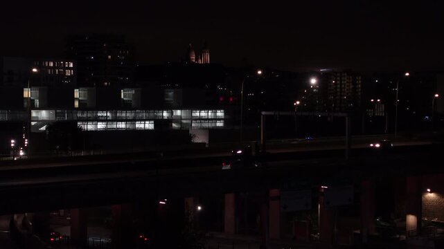 Cars and trucks driving on a busy motorway at night. Night traffic on the highway