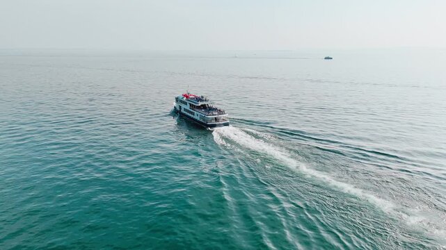 Public ferry on Lake Garda transporting passengers between lakeside towns, water transport in Italy