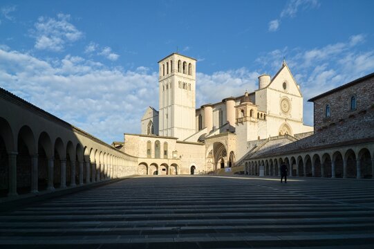 Lower square Piazza Inferiore with historic arcades leading to the Basilica of Saint Francis in Assisi, Italy.