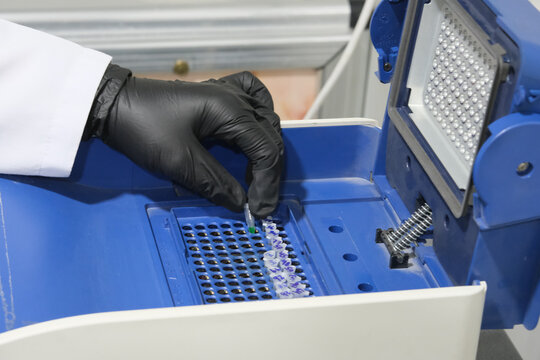 BASRA, IRAQ - NOVEMBER 7, 2021: CLOSEUP PHOTO OF PUTTING PCR TUBES THE THERMOCYCLER MACHINE