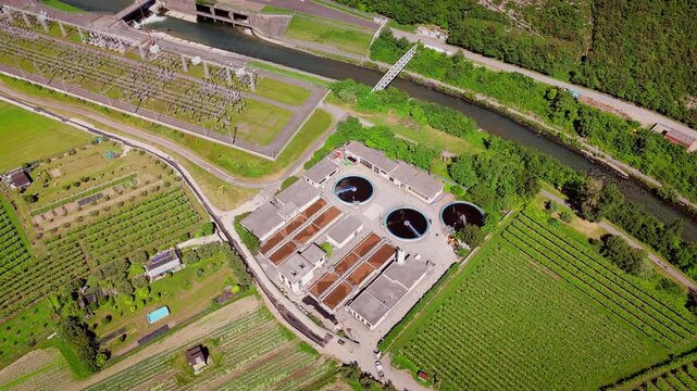 Wastewater treatment facility with clarifier tanks and pipelines, aerial view. Industrial infrastructure for municipal water purification