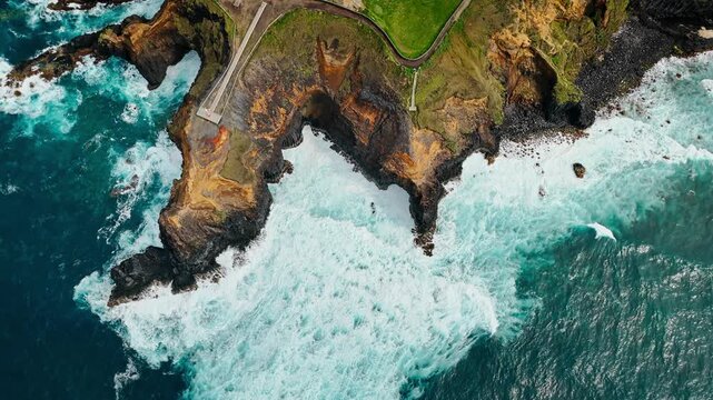 Wide aerial view of Atlantic waves along volcanic coastline of Azores. Powerful ocean swell and breaking waves