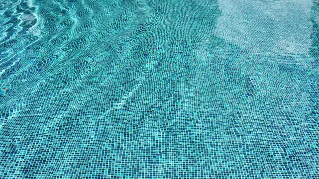 Swimming pool with blue crystal clear water surface and ripple wave background