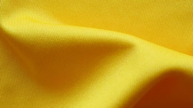 Yellow sports clothing fabric football shirt jersey texture close up