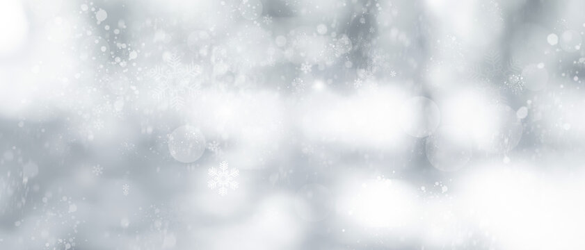 Blurred glitter effects background. Bright soft blue with hints of pearl color. Christmas background. Festive Christmas backdrop with holiday charm. Blurred bokeh light on dark blue background.