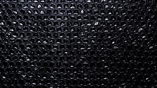Dense Small Bubble Wrap Pattern on Black Background