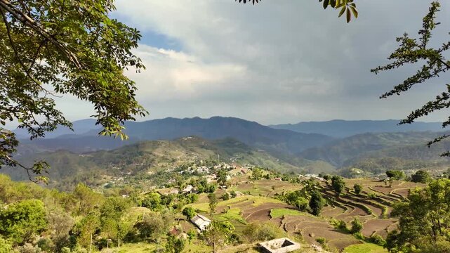 Scenic View of a Mountain Village with Terraced Farming in a Lush Valley