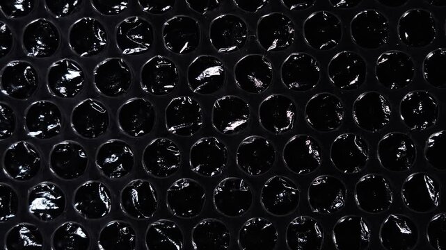 Macro Texture of Bubble Wrap on Black Background