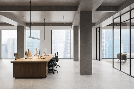 Modern open‑plan office interior with minimalist furniture, large windows, concrete columns, and sleek workstations overlooking a city skyline. 3D Rendering