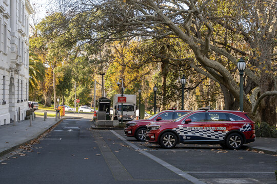 Australian Federal Police vehicles are parked near heritage government buildings at Treasury Place, East Melbourne, Australia.