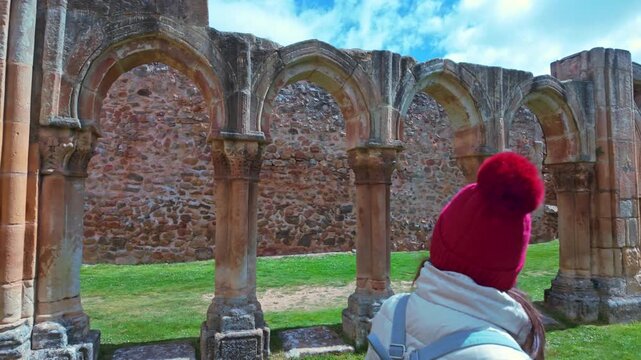 Female tourist exploring the Monastery of San Juan de Duero in Soria, Spain