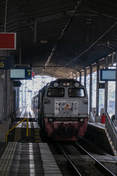 Solo, Indonesia - June 15, 2026: Front cab of a KAI long-distance locomotive standing at Solo Balapan Station under the platform roof, ready for passenger service.