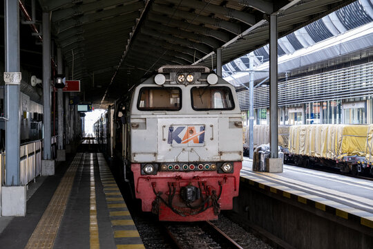 Solo, Indonesia - June 15, 2026: Front cab of a KAI long-distance locomotive standing at Solo Balapan Station under the platform roof, ready for passenger service.