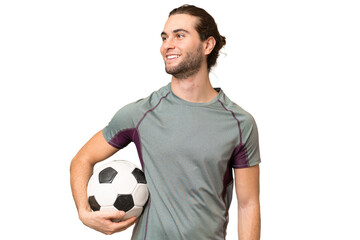 Young handsome football player man over isolated background looking side © luismolinero