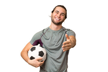 Young handsome football player man over isolated background shaking hands for closing a good deal © luismolinero