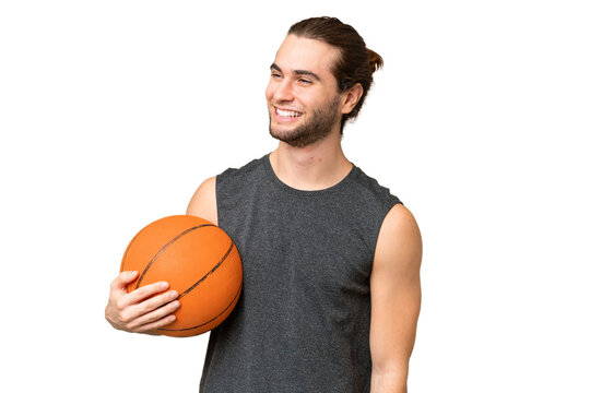 Young basketball player man over isolated background looking to the side and smiling
