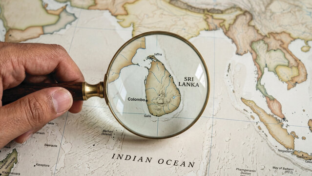 Magnifying Glass Highlighting Sri Lanka on World Map &ndash; Travel Research Concept &ndash; Close-Up