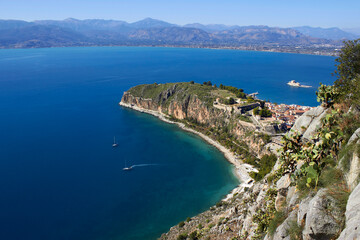 Obraz premium High angle view of Acronauplia fortress and Nafplio town with cactus plant in the foreground under a clear sky in Greece