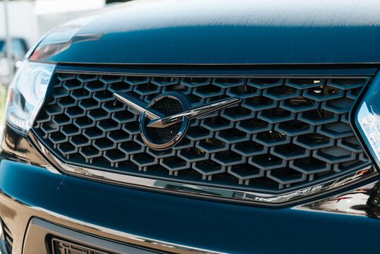 close-up view of a car front grill, prominently displaying the UAZ brand's emblem. The setting is an automotive exhibition where various cars are showcased to the public Smolensk, Russia 07.17.2026