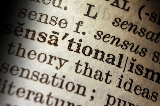 Word sensationalism on dictionary page, macro close up