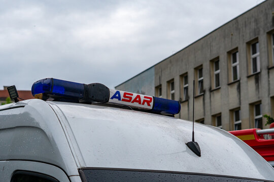 Close up on roof of white rescue van with mounted blue warning beacon light with ASAR inscription during urban emergency services exercise.