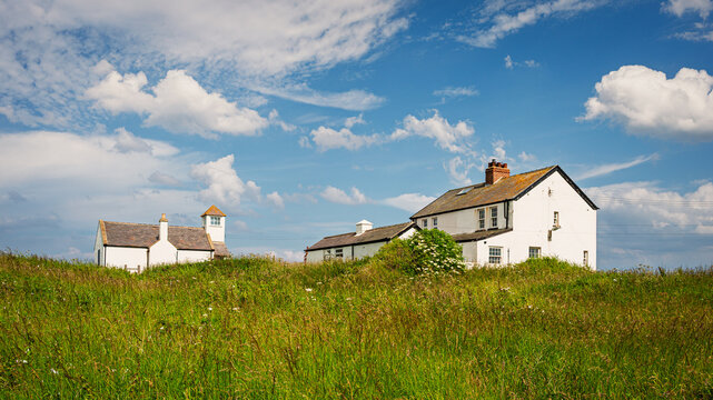 Buildings of the Watch House Museum at Seaton Sluice, a village on the Northumberland coastline, with a rugged shore at Collywell Bay