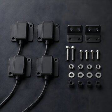 Accelerometer Collection with Mounting Hardware on Dark Laboratory Surface for Precision Vibration Testing Applications Research