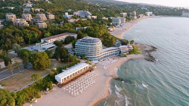 Saints Constantine and Elena Bulgaria sand beach aerial view drone shot sunset, Bulgarian Black Sea coast resort waterfront sunbeds, summer travel destination background