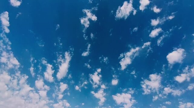 The beauty of a clear blue sky filled with small white clouds (cumulus fractus). These clouds swept rapidly across the sky before gradually fading away, leaving behind a vast expanse of clean,