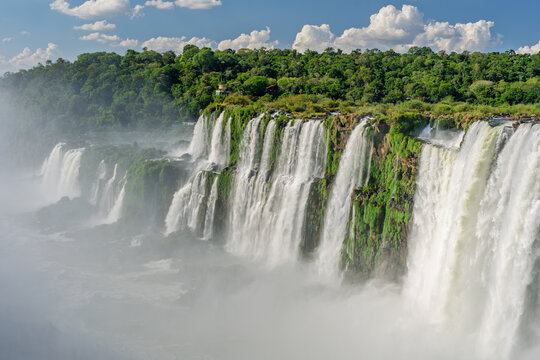Scenic view of a massive waterfall cascading over a lush green cliff in Brazil