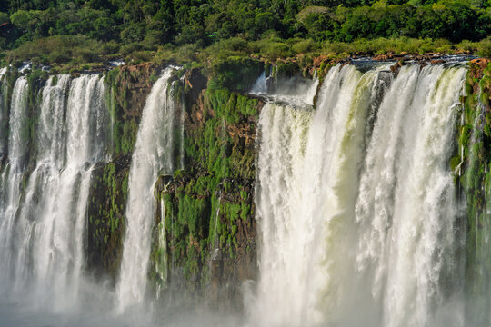 Scenic view of a large waterfall cascading over a lush green cliff in Brazil