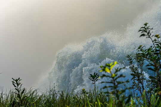 Powerful waterfall cascading in Brazil with lush green vegetation in the foreground
