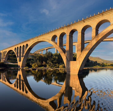 Reflection of the two of the Peso da Regua bridges over the Douro river: the Regua Road Bridge and the Miguel Torga bridge, Regua, Vila Real, Portugal